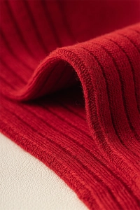 Macro shot of high-quality red ribbed knit cotton fabric texture for New Year socks