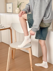 Close-up of white breathable mesh ankle socks for men with elastic ribbed cuffs