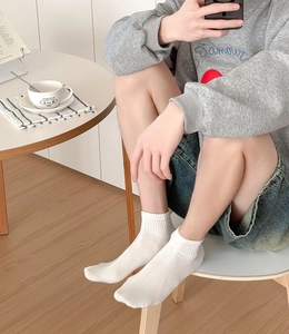 Close-up of white breathable ankle socks with mesh texture for casual everyday wear