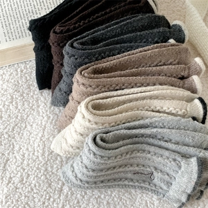 Winter wool socks for women in multiple colors with knit texture and cozy home aesthetic