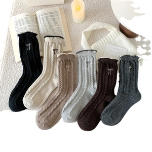 Winter wool socks for women featuring cable knit patterns and cute bow accents in six colors