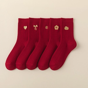 Detail of five pairs of red cotton socks with gold zodiac and floral embroidery