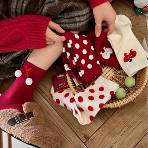 Festive red and white Christmas crew socks for women featuring polka dots and cute patterns
