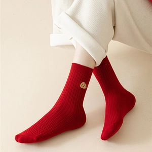 Detailed close-up of red cotton crew socks featuring a cute biscuit pattern embroidery