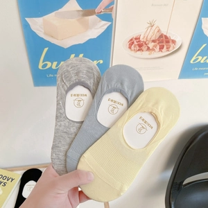 Detailed knit texture of invisible non-slip socks in grey, blue, and yellow set