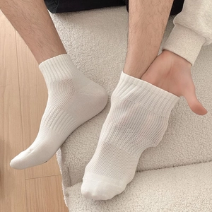 Close-up showing the elasticity and breathable mesh of men's white cotton sports socks