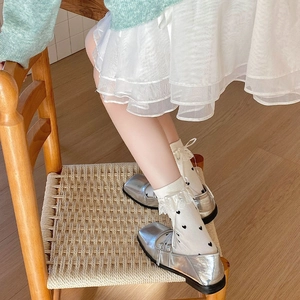 Silver metallic Mary Jane shoes with white lace socks featuring black heart jacquard