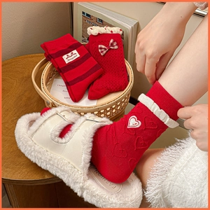 Red bow cotton socks and plush slippers set for New Year in cozy home setting