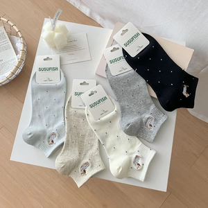 Detailed view of five cotton socks with cute puppy embroidery and dot patterns