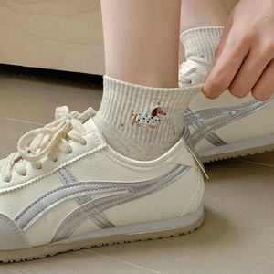 Cute beige embroidered cotton socks with dog pattern and vintage sneakers for women