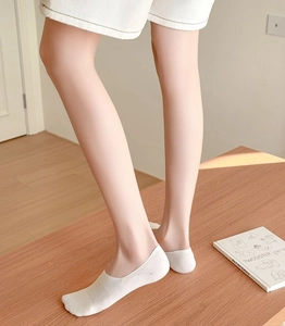 Close-up of white invisible low-cut socks with ribbed edges on model's foot
