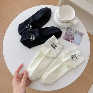 Detail of embroidered puppy and cute puppy text on premium cotton ankle socks