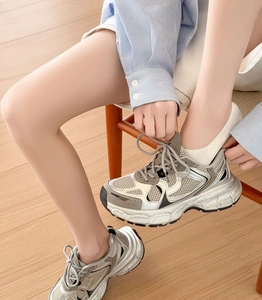 Detail of silver and grey chunky dad sneakers with mesh panels and layered design
