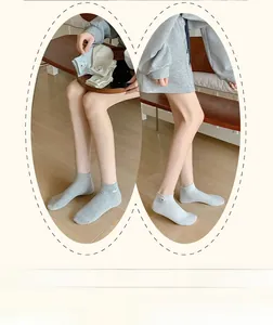 Détail de broderies de chiots et motifs à pois sur des chaussettes en coton pour femmes