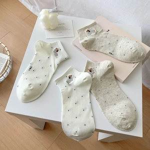 Close-up of cute dog embroidery and polka dot patterns on breathable cotton socks
