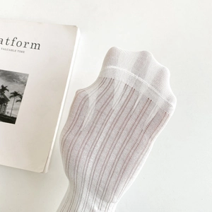 Close-up of white translucent ribbed socks with high elasticity and breathable texture