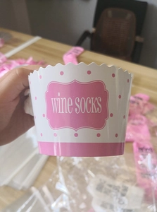 Pink cupcake gift box with Wine Socks text and white polka dots for creative gift packaging