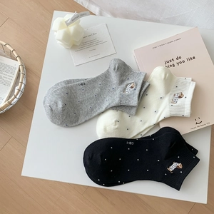 Detail of cotton ankle socks with cute puppy embroidery and polka dot patterns