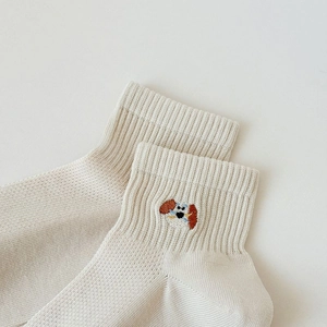 Close-up of cute puppy embroidery and ribbed cuff on off-white cotton crew socks