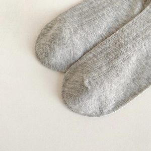 Detail of grey knitted cotton socks showing the seamless reinforced toe stitching