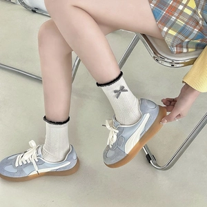 Women's light blue suede sneakers with lettuce trim bow socks and retro brown gum soles