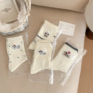 Detail of cotton women socks with cute dog embroidery and stylish frill cuff design