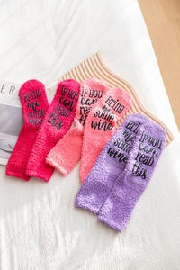 Detail of soft coral fleece socks with If You Can Read This Bring Me Some Wine text