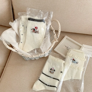 Close-up of premium breathable socks with cute puppy embroidery in frosted zipper bags