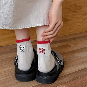 Combed cotton socks with embroidered cute puppy and red stripes shown on model feet