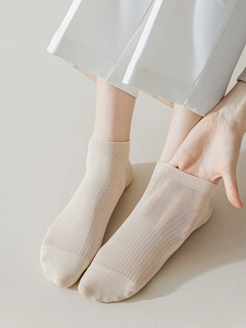 Close-up of beige ultra-thin breathable modal socks showing elastic rib knit texture