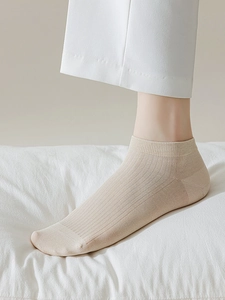 Detailed texture of thin breathable modal mesh socks with ribbed cuffs in beige