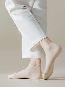 Close-up of cream low-cut socks featuring breathable vertical ribbed texture on the ankle