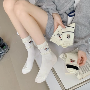 Detailed view of breathable mesh socks featuring delicate embroidered dachshund patterns