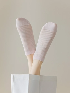 Detail of light pink modal mesh socks showing the vertical ribbed knit texture