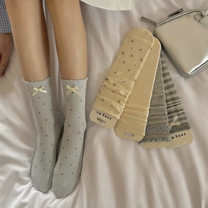 Detail view of Japanese style light blue bow socks and striped cotton crew socks for women