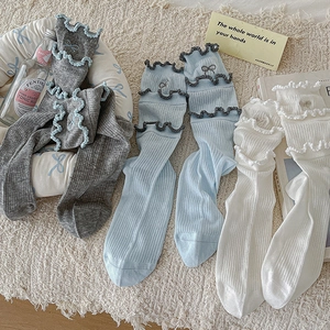 Three pairs of pastel cotton crew socks with ruffled edges and tiny bow embroidery