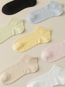 Detail of colorful breathable cotton socks with vertical ribbed texture in pastel shades