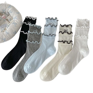 Five pairs of ruffled mid-calf cotton socks in pastel colors with sweet bow details