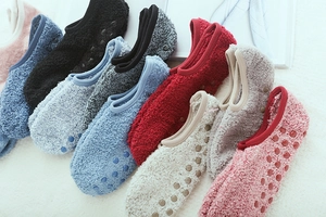 Close-up of multi-colored coral fleece floor socks with anti-slip silicone dot soles