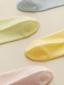 Close-up of pastel ribbed knit socks in light blue, yellow, and pink colors