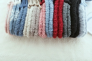 Macro view of plush coral fleece winter socks in multiple soft colors and ribbed cuffs