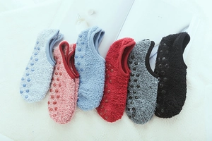 Detail of coral fleece socks showing various colors and anti-slip silicone dots on sole