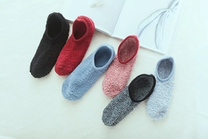 Detailed close-up of six assorted colors of warm coral fleece anti-slip slipper socks