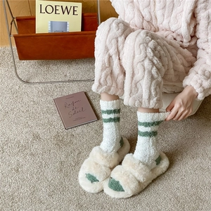 Cozy winter set with green striped fuzzy socks, plush slippers and coral fleece loungewear