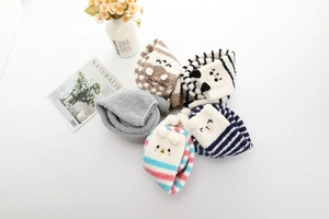Détail de chaussettes d'hiver en polaire corail avec icônes d'animaux et rayures