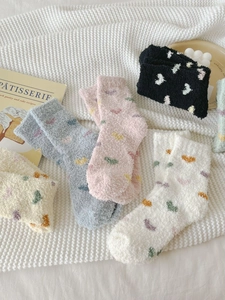 Detail view of thick fuzzy heart socks in assorted colors with cozy fleece material