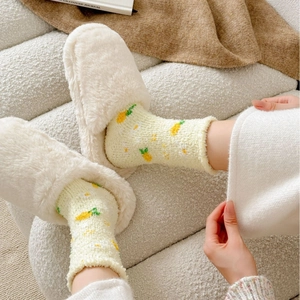 Cosy coral fleece socks and plush slippers set for women in warm home setting