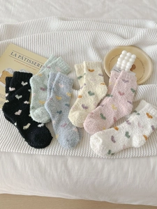 Detailed view of six pairs of thick coral fleece warm socks in assorted soft pastel colors