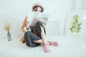 Detail of soft pink coral fleece slipper socks with non-slip silicone grip for winter home