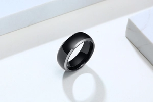 Macro view of polished black tungsten ring with sleek silver beveled edges for men